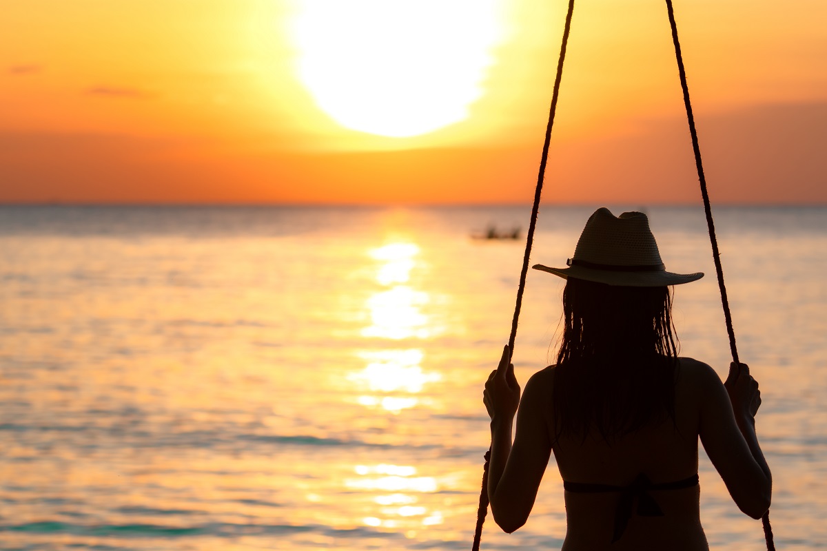 Silhouette Woman Wear Bikini And Straw Hat Swing The Swings At T