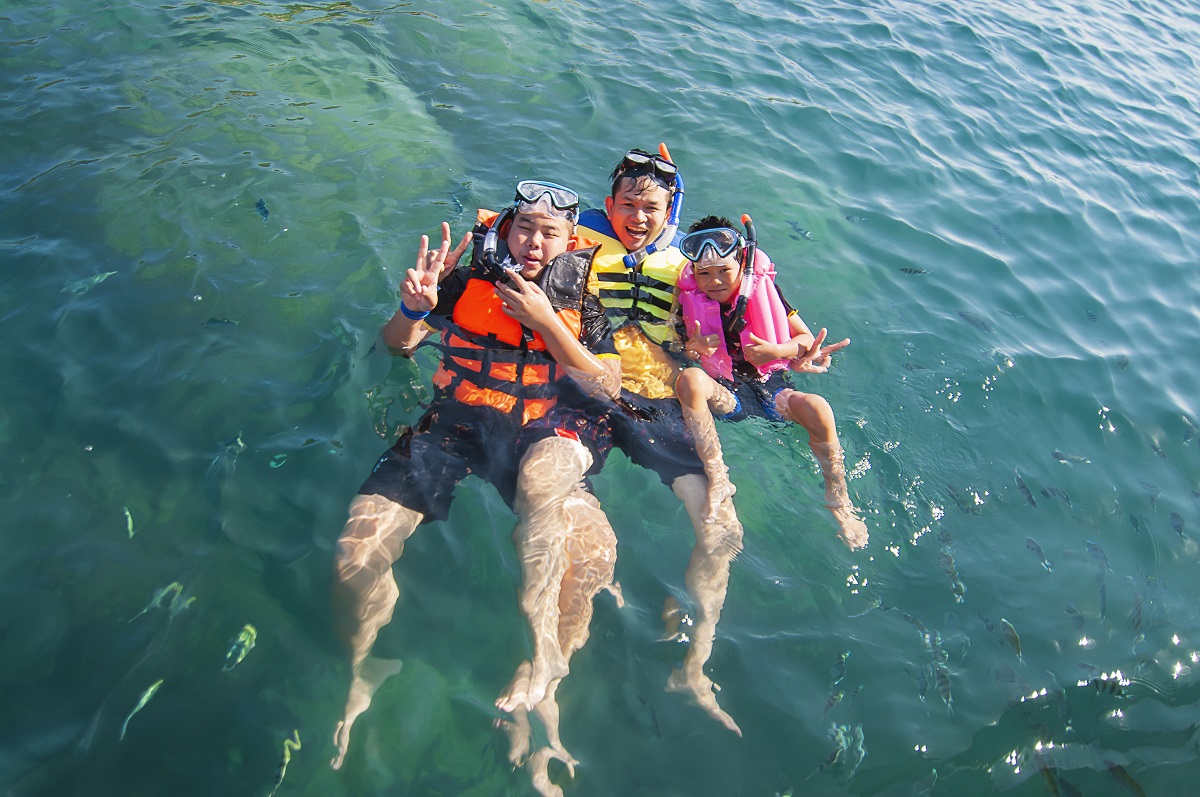 Three Guys Floating Happily In The Sea Water
